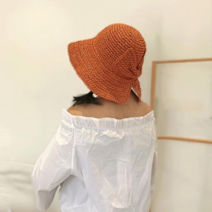 Chic wide-brim sun hat featuring a large bow, providing stylish UV protection for women