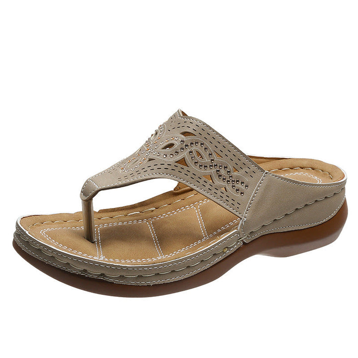 Pair of women's casual summer sandals with rhinestone accents and orthopedic arch support