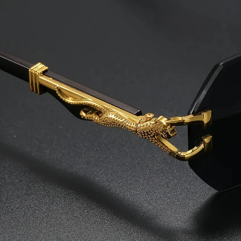 Designer women's geometric rimless sunglasses. Sculptural gold panther detail, luxury fashion with UV protection.