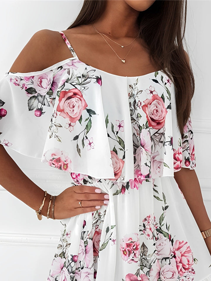 Elegant women's cold shoulder mini dress featuring a vibrant romantic floral print, ideal for spring fashion.