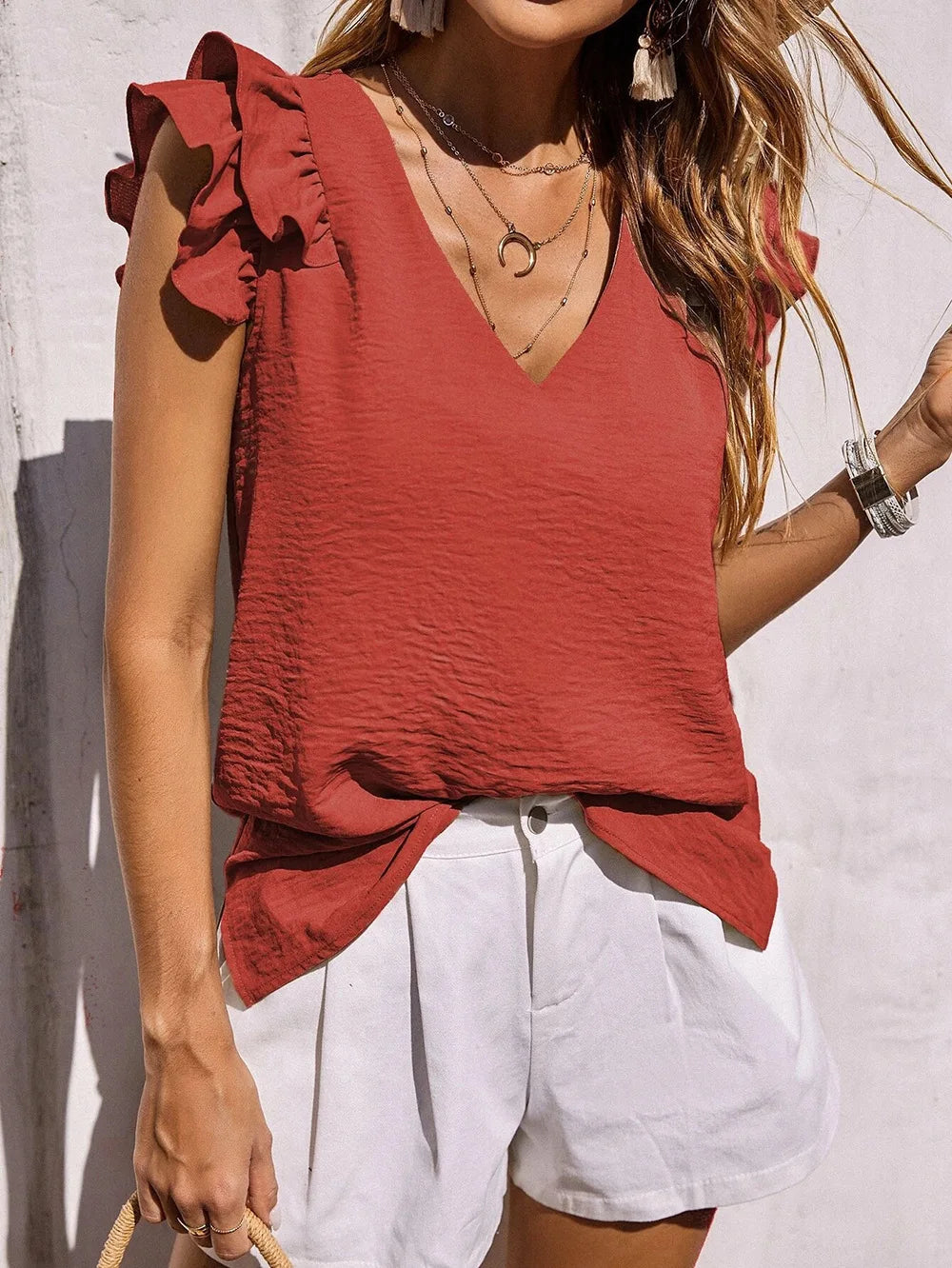 Stylish women's summer top showcasing beautiful ruffle sleeves, a comfortable flowy fit, and a classic V-neck.