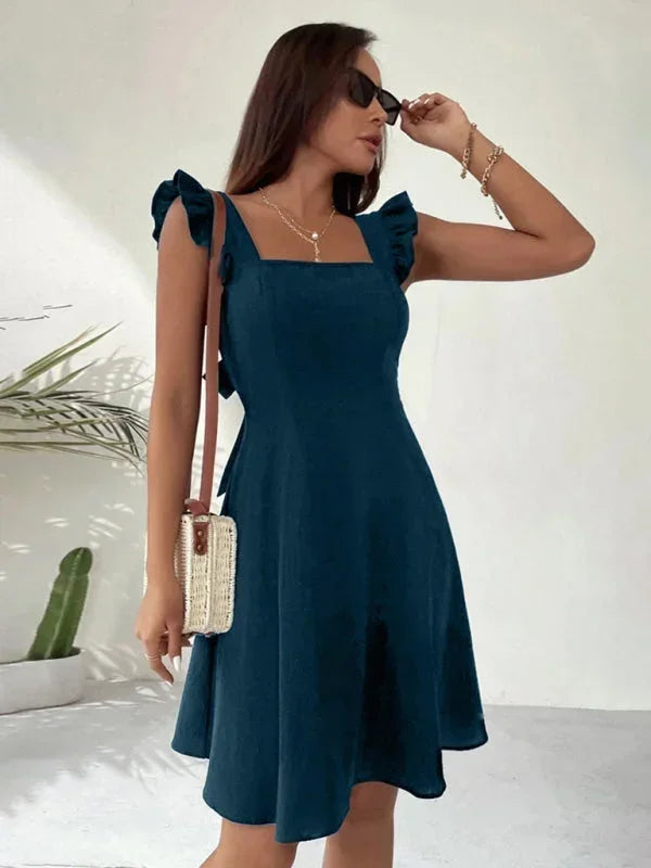 Fashionable women's mini dress, A-line cut with ruffle straps and a charming bow back detail.
