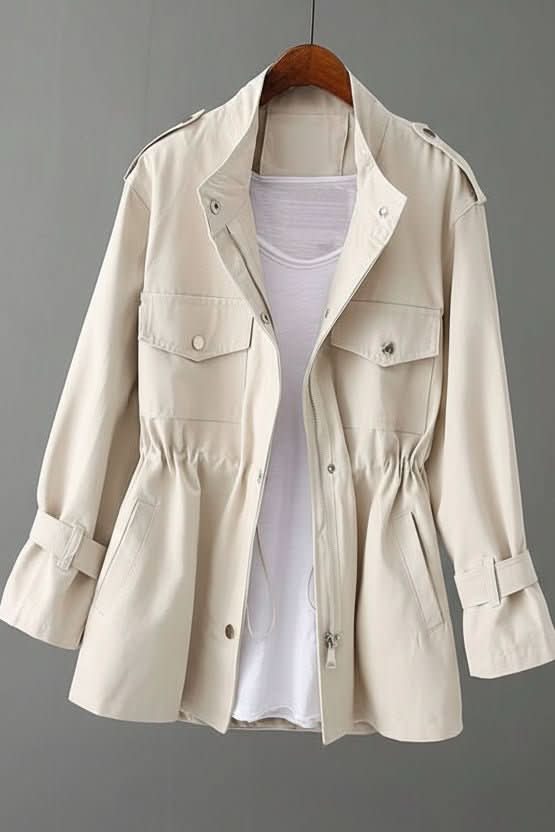 Rugged women's utility jacket with a stylish open back detail, perfect for contemporary street style looks.