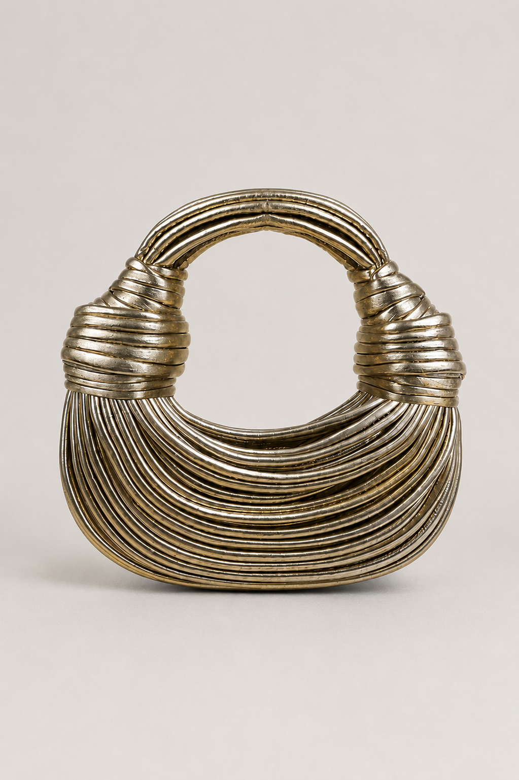 Women's sculptural crescent shoulder bag with unique loop-handle. Modern & elegant handbag for chic style.