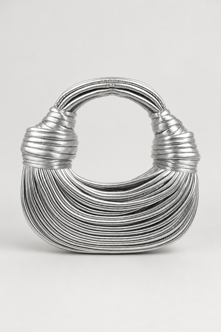 Chic women's crescent handbag, featuring a distinctive sculptural knot handle. Versatile everyday fashion bag.