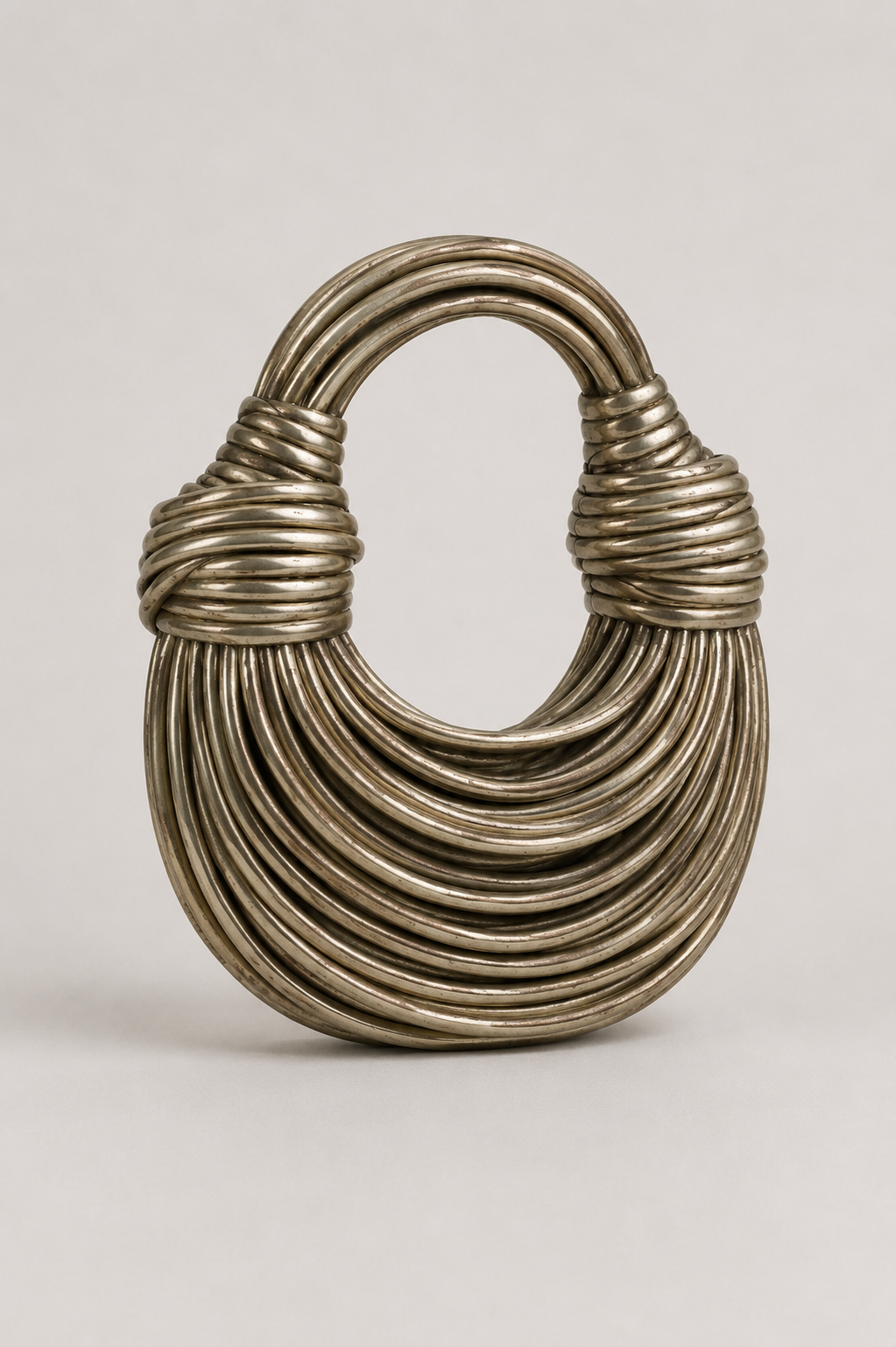 Distinctive women's crescent shoulder bag, featuring a unique sculptural loop-handle. Chic & versatile modern handbag.