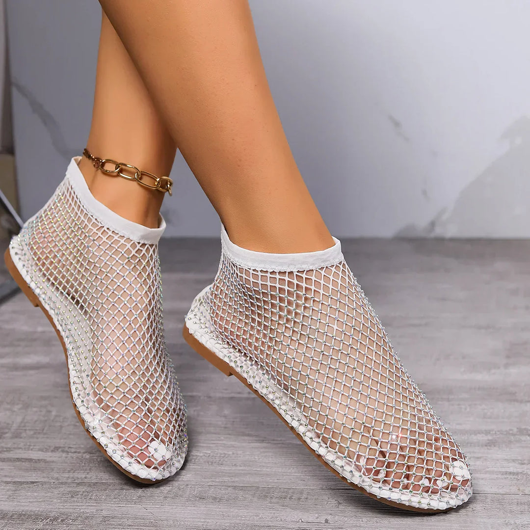 Elegant women's rhinestone flats with instep strap, providing shimmering comfort for day to night occasions.