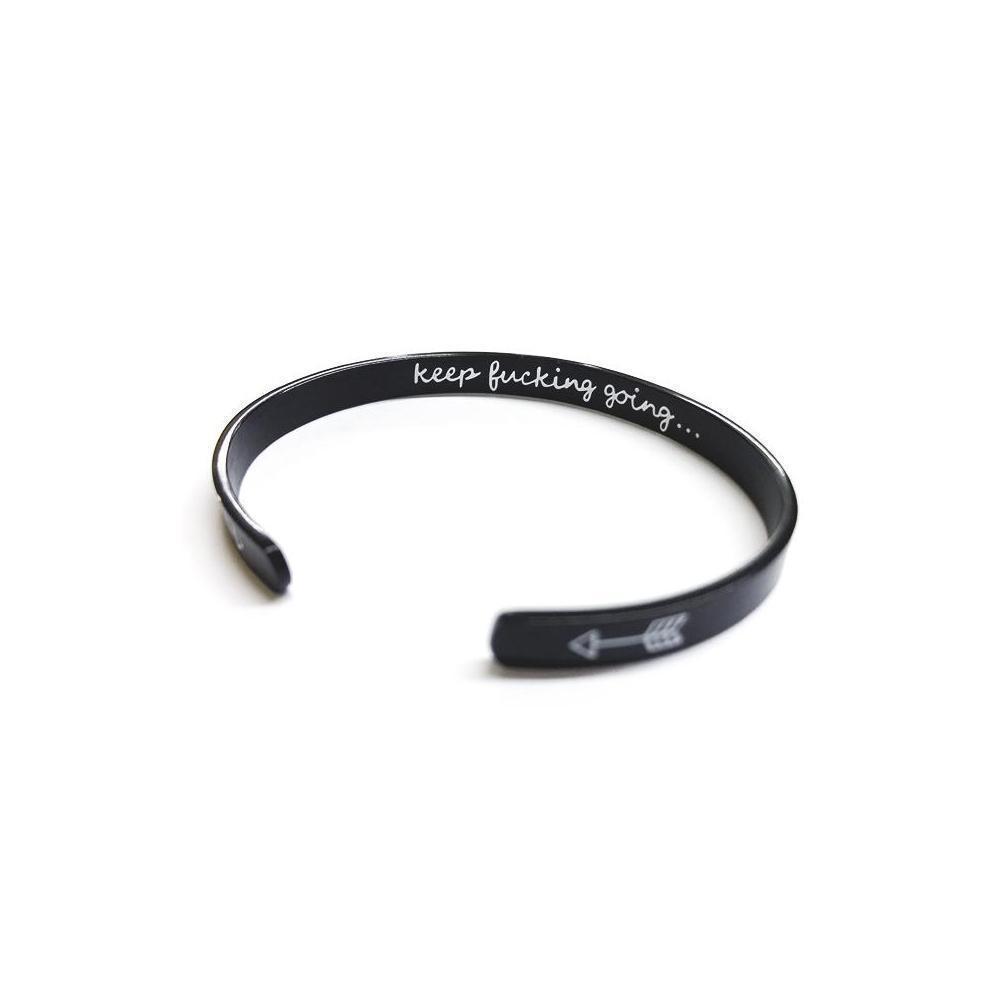 Closeup of engraved message on a silver women's cuff bangle, motivational jewelry