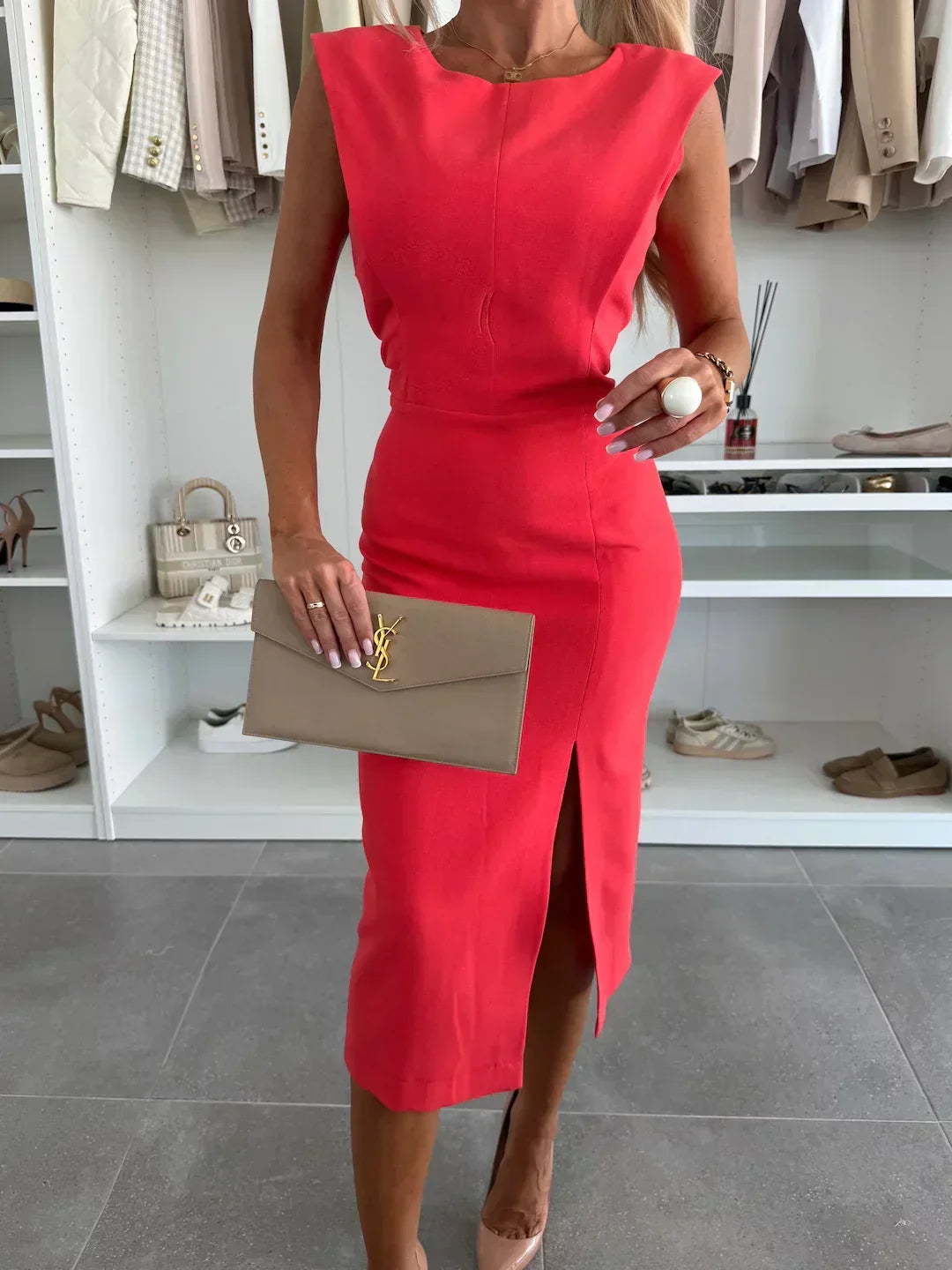 Modern women's sleeveless bodycon midi dress featuring an alluring side slit; ideal for parties & evening fashion.