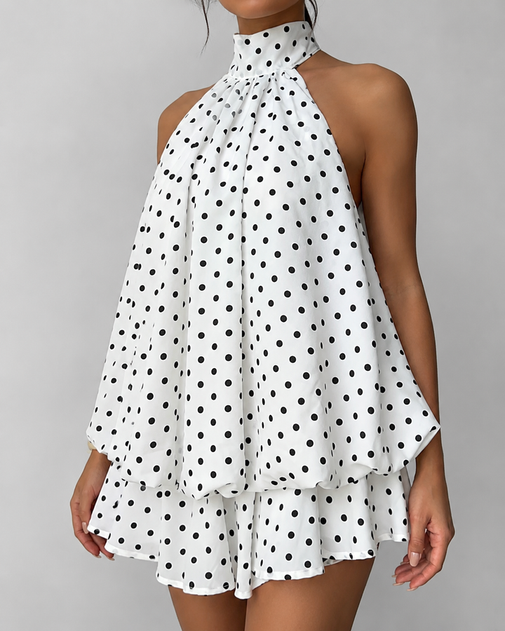 Party-ready women's sleeveless mini dress with a stylish halter neck, flirty ruffle hem, and captivating open back.
