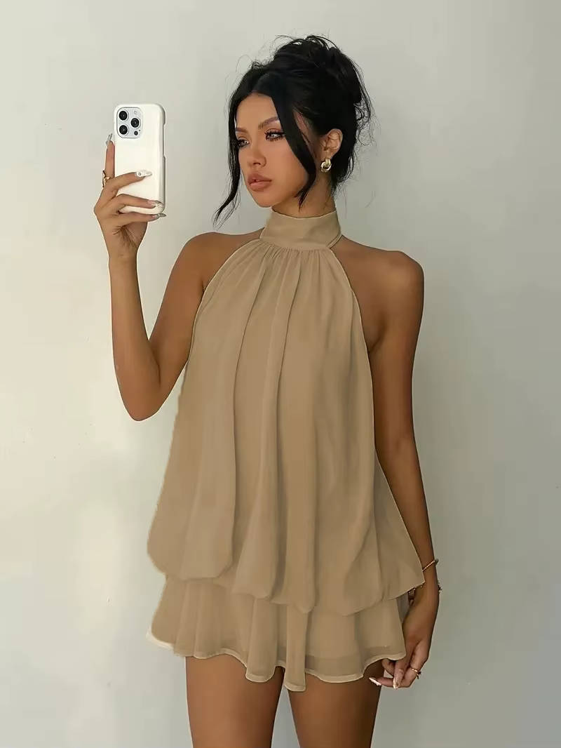Black women's sleeveless halter mini dress with ruffle hem & open back; a sophisticated option for cocktail parties.