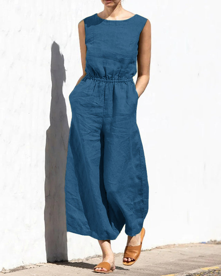Front view of a women's sleeveless wide leg jumpsuit, showcasing its elegant drape & comfortable fit.