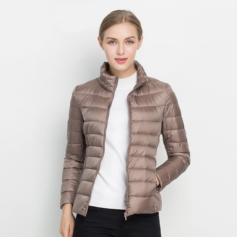 Women's slim fit insulated puffer winter coat in black, front view, showcasing quilted design & warmth.