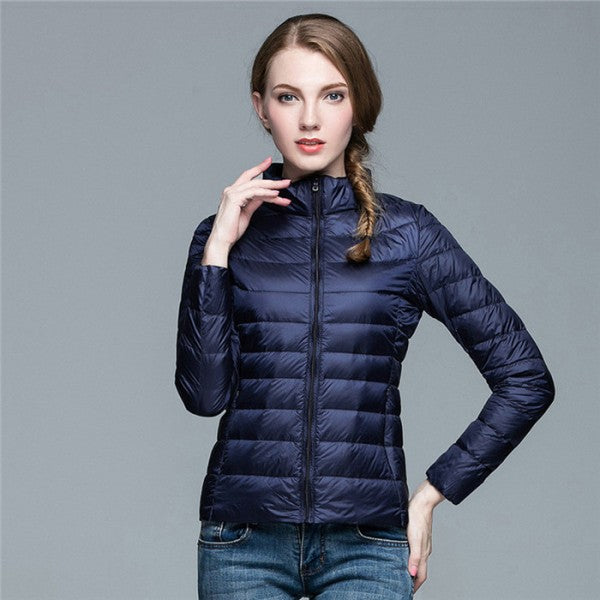 Fashionable women's slim fit puffer coat for winter, side view, highlighting tailored silhouette & insulation.