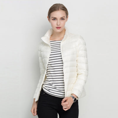Close-up of women's insulated puffer winter coat, showing durable fabric texture and warm collar detail.