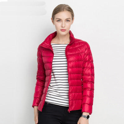 Stylish women's warm puffer coat, slim fit, in deep navy, perfect for winter outdoor activities.