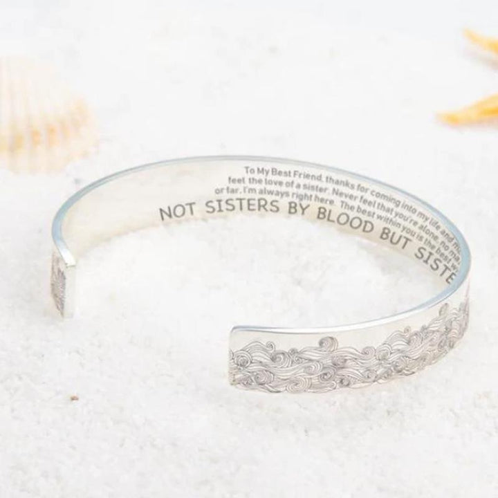 Hand modeling a stainless steel open wave bracelet, elegant and shiny