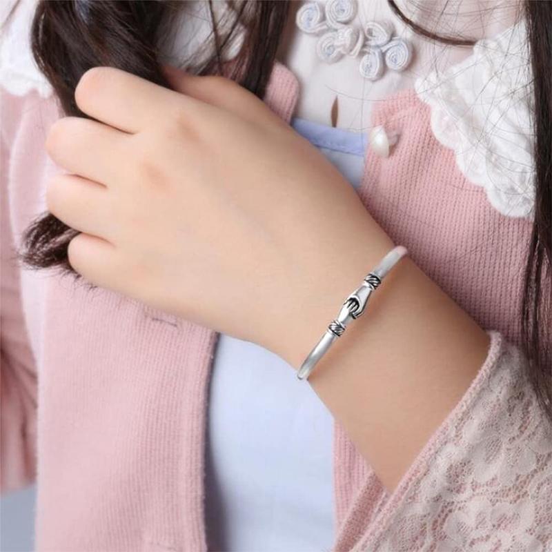 Sterling silver handshake bracelet displayed in gift packaging, perfect for any occasion