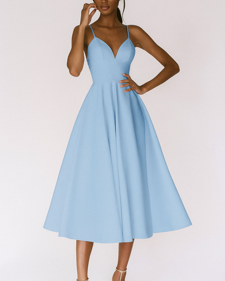 Detailed back view of a women's strappy green midi dress, highlighting the elegant design for wedding guests.