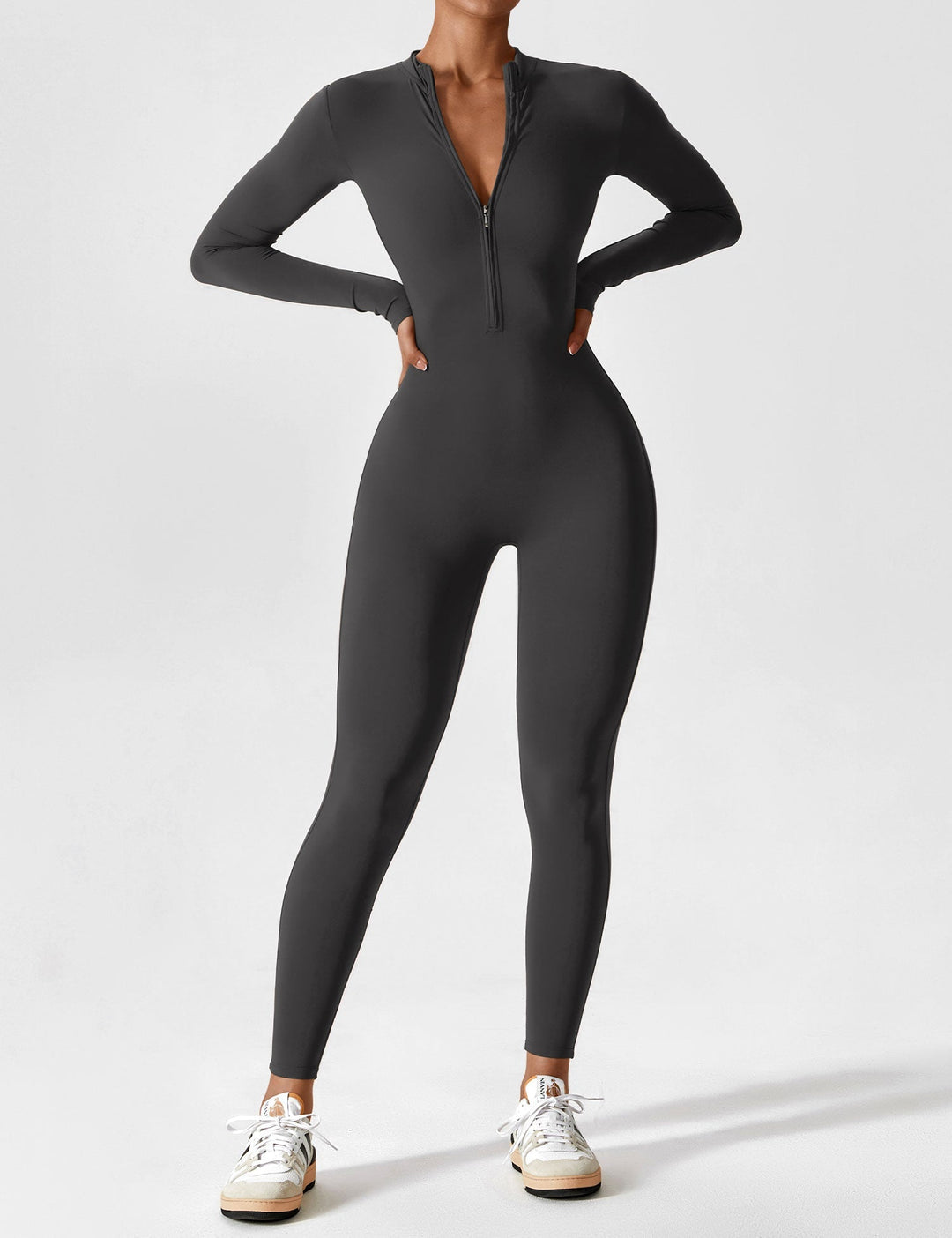 Women's comfortable stretchy zip-up jumpsuit at a cafe, embodying relaxed spring urban fashion