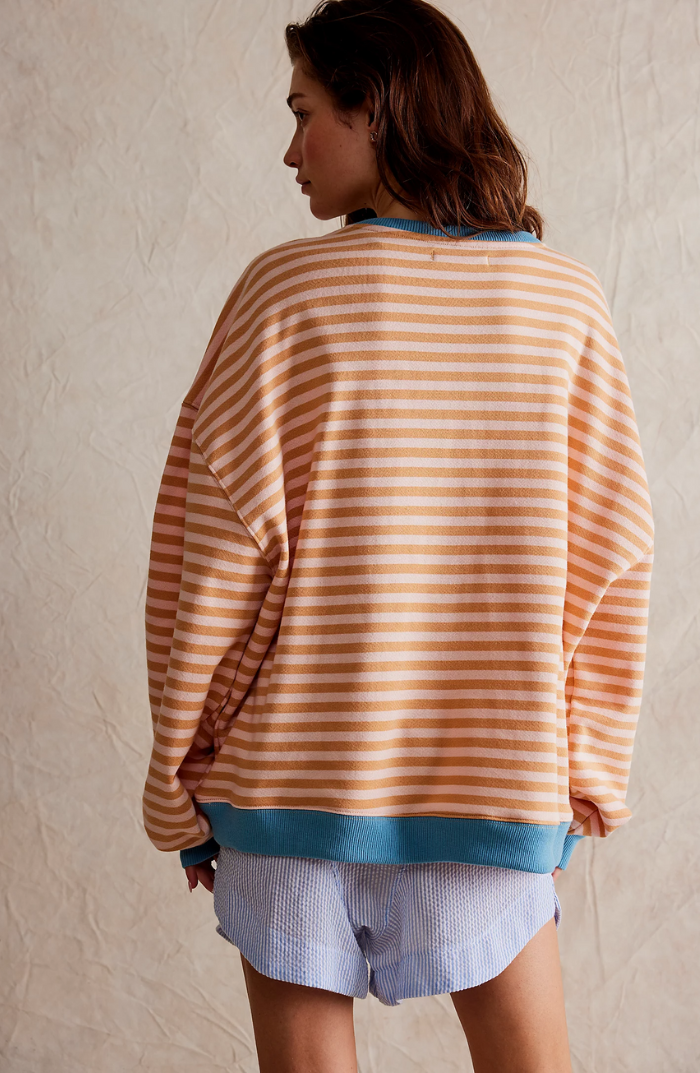 Three-quarter view of a women's striped crewneck knit sweater, showing its relaxed drape