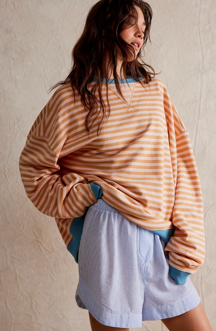 Model wearing a casual women's striped crewneck sweater, ideal for everyday style
