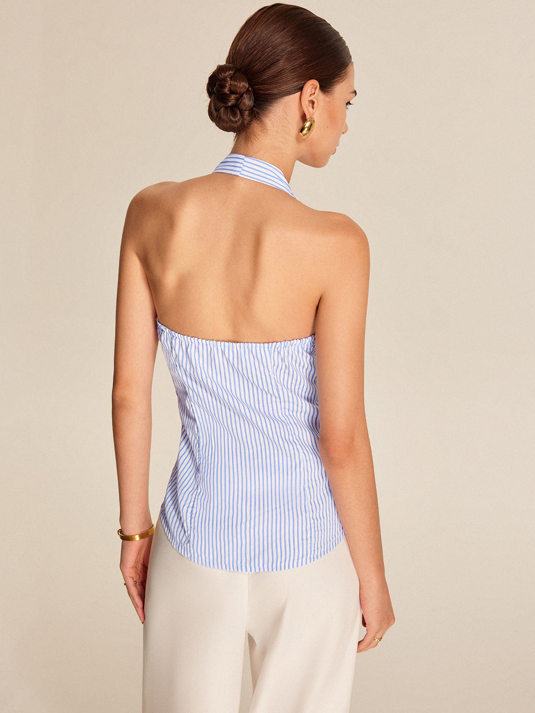 Fashionable women's sleeveless striped top. This halter tie-front blouse is perfect for work, office, & summer style.