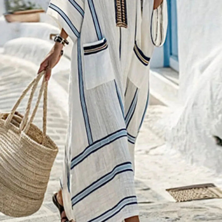 Comfortable women's striped maxi kaftan dress featuring a V-neck and pockets, great for beach or resort.