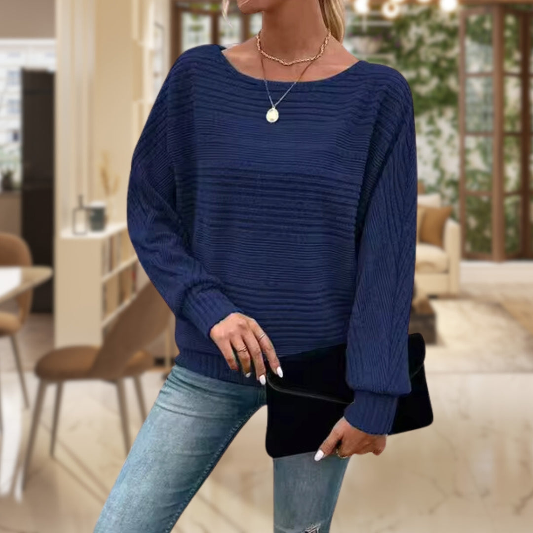 Close-up of a women's striped knit jumper, showcasing soft texture and classic striped pattern. Everyday comfort.