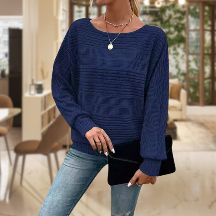 Close-up of a women's striped knit jumper, showcasing soft texture and classic striped pattern. Everyday comfort.