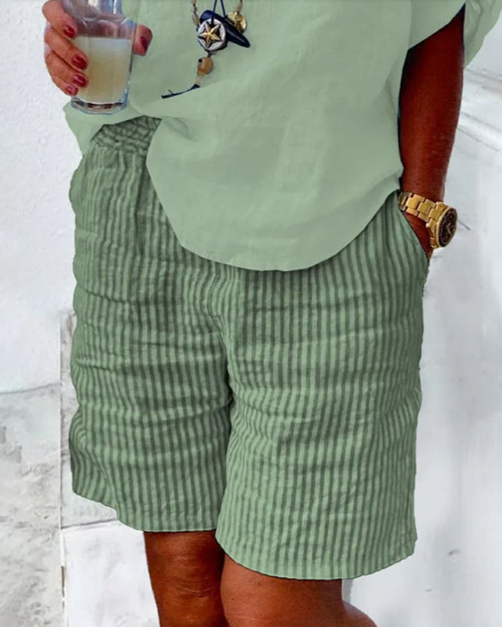 Lightweight women's striped shorts with mid-rise waist and pockets, essential for summer comfort.