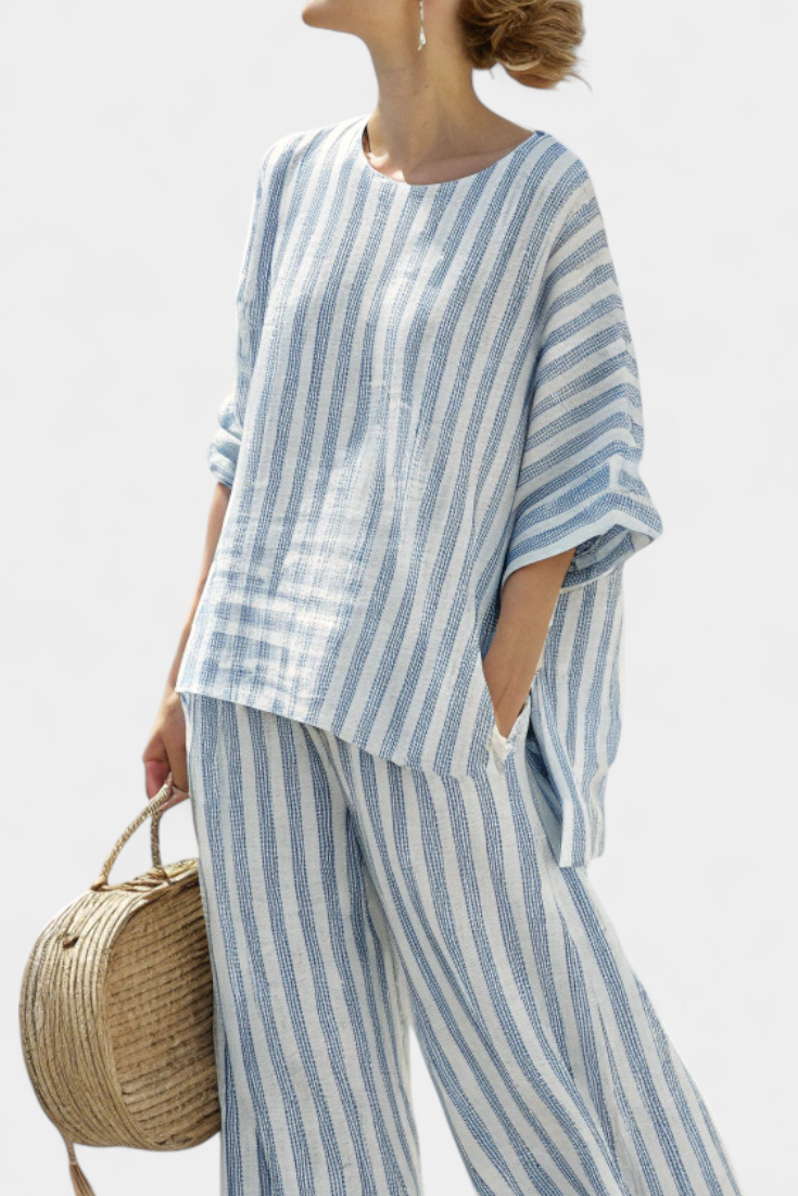 Relaxed fit women's two-piece striped set featuring a batwing top & wide-leg pants, ideal for vacation.