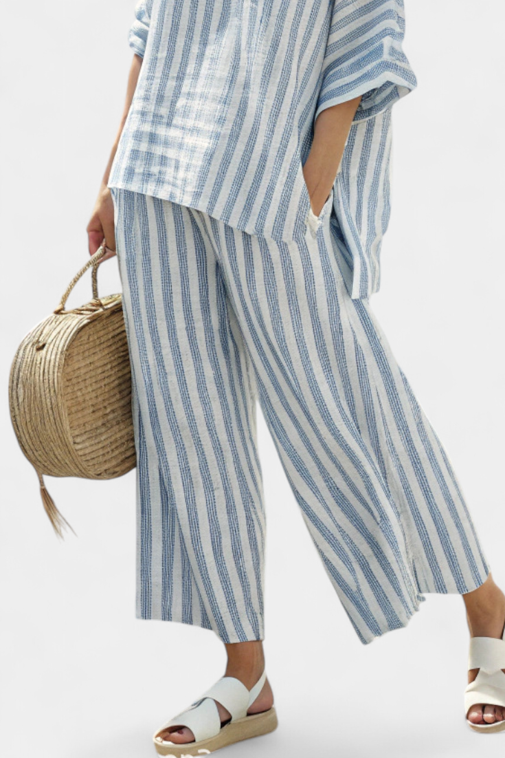 Chic women's striped coord set with oversized batwing top & wide-leg pants, offering casual elegance.