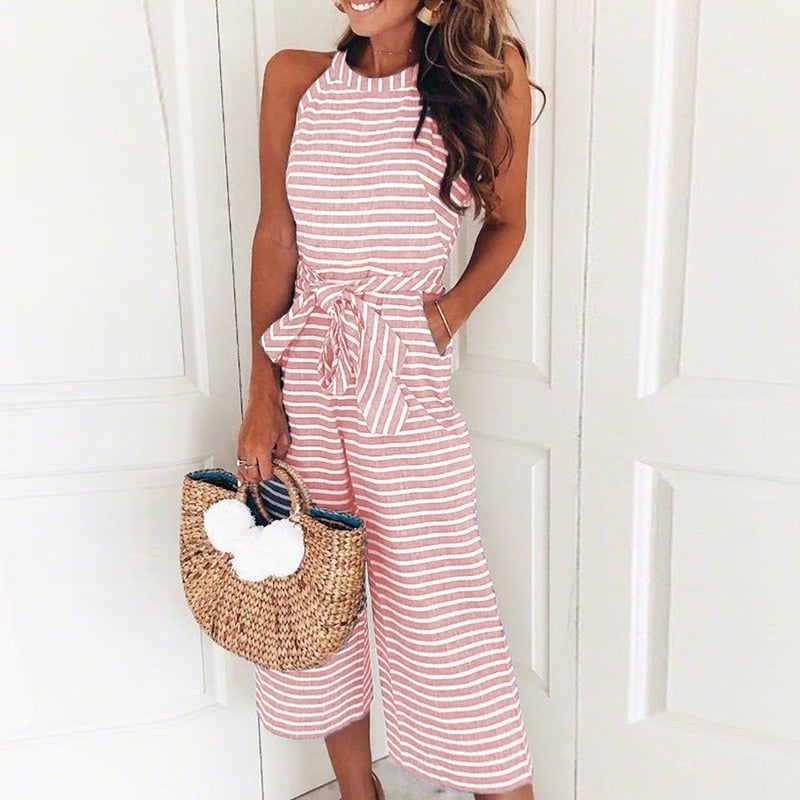 Fashionable women's striped jumpsuit with a sleeveless wrap V-neck and flowing wide leg design.