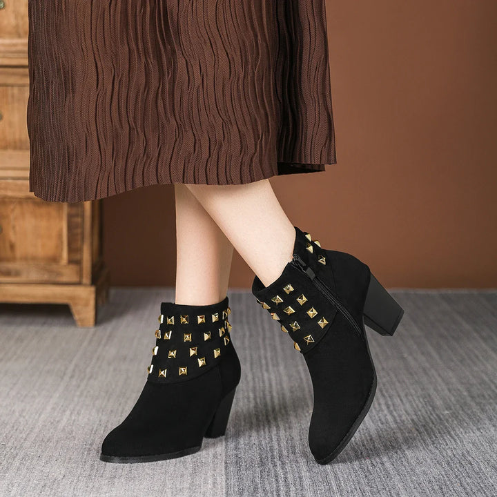 Fashion flat lay with women's studded ankle boots. Essential footwear for a chic casual look.