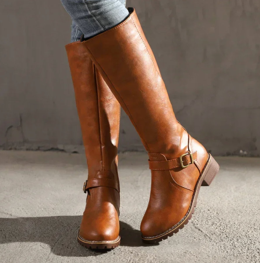 Women's stylish black leather knee-high boots, perfect for elegant winter and fall fashion.