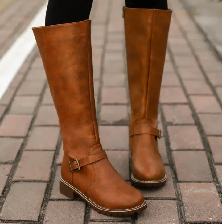 Classic women's knee-high leather boots in dark brown, versatile for various fashion outfits.