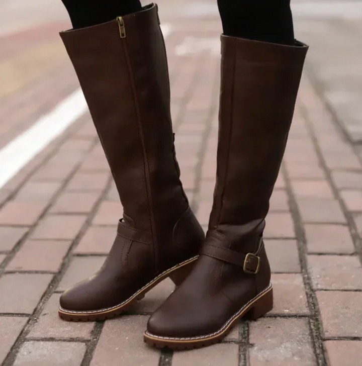Fashionable women's knee-high leather boots with a sleek design, ideal for elegant footwear.