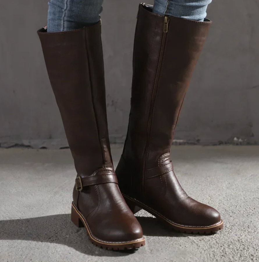 Pair of women's comfortable black leather knee-high boots, great for fall and winter seasons.