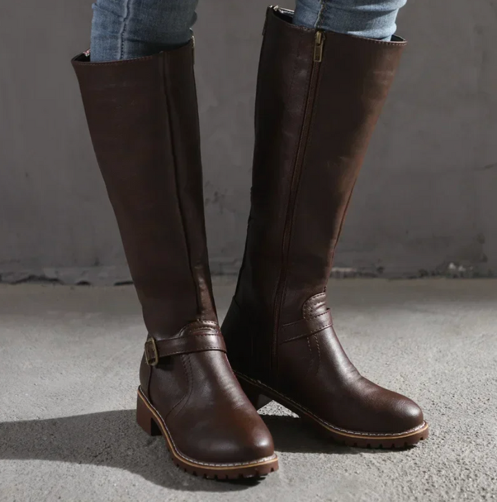 Pair of women's comfortable black leather knee-high boots, great for fall and winter seasons.