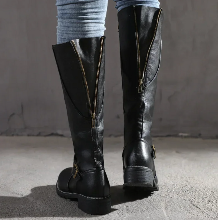 Elegant women's knee-high leather boots with a subtle heel, suitable for stylish winter fashion.