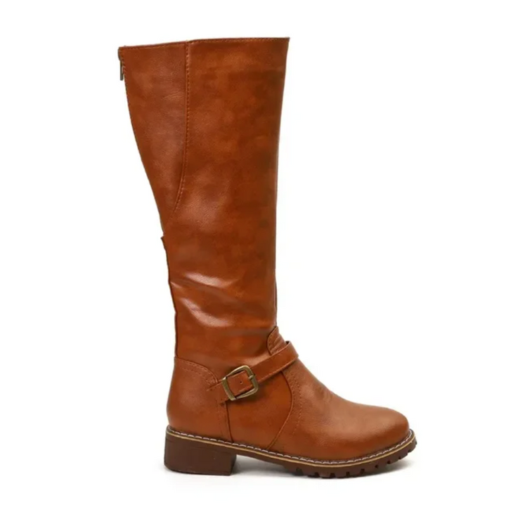 Close-up of the textured leather on women's knee-high boots, showcasing quality and style.