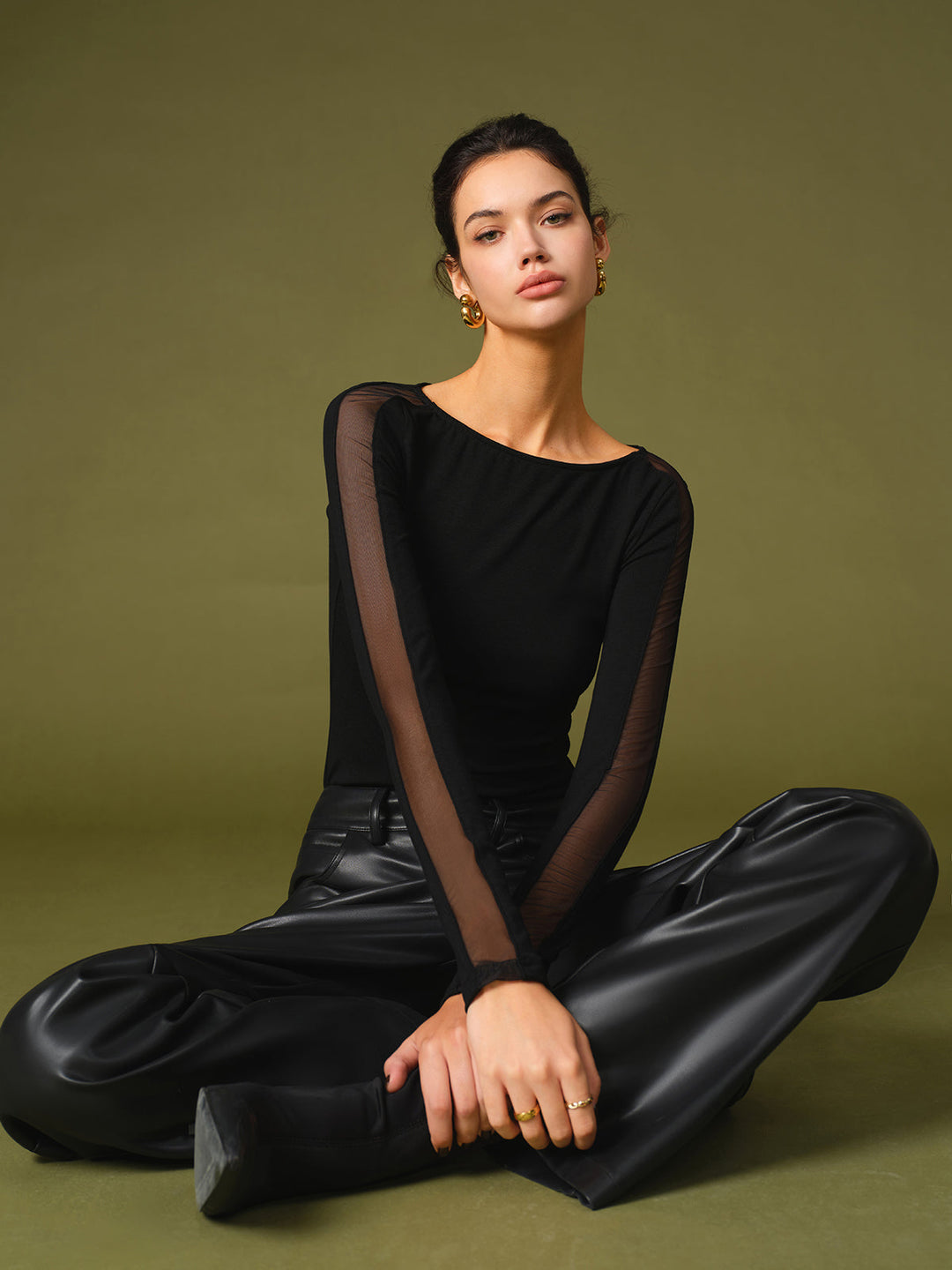 Black T-shirt for women featuring trendy mesh sleeves, ideal for casual outfits