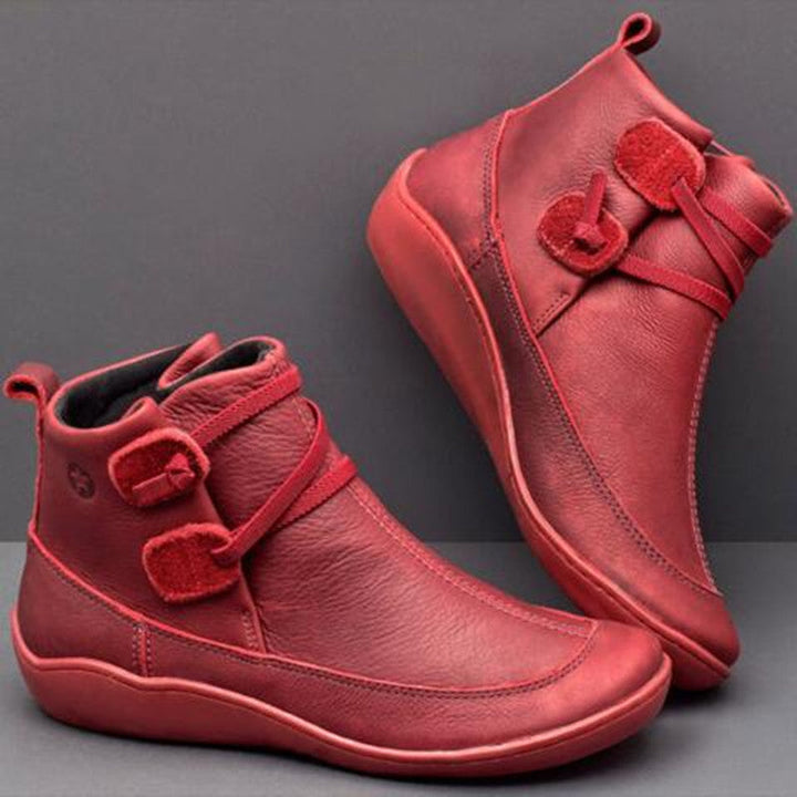 Women's stylish orthopedic ankle boots with button detail, offering arch support & wide toe box for comfort.