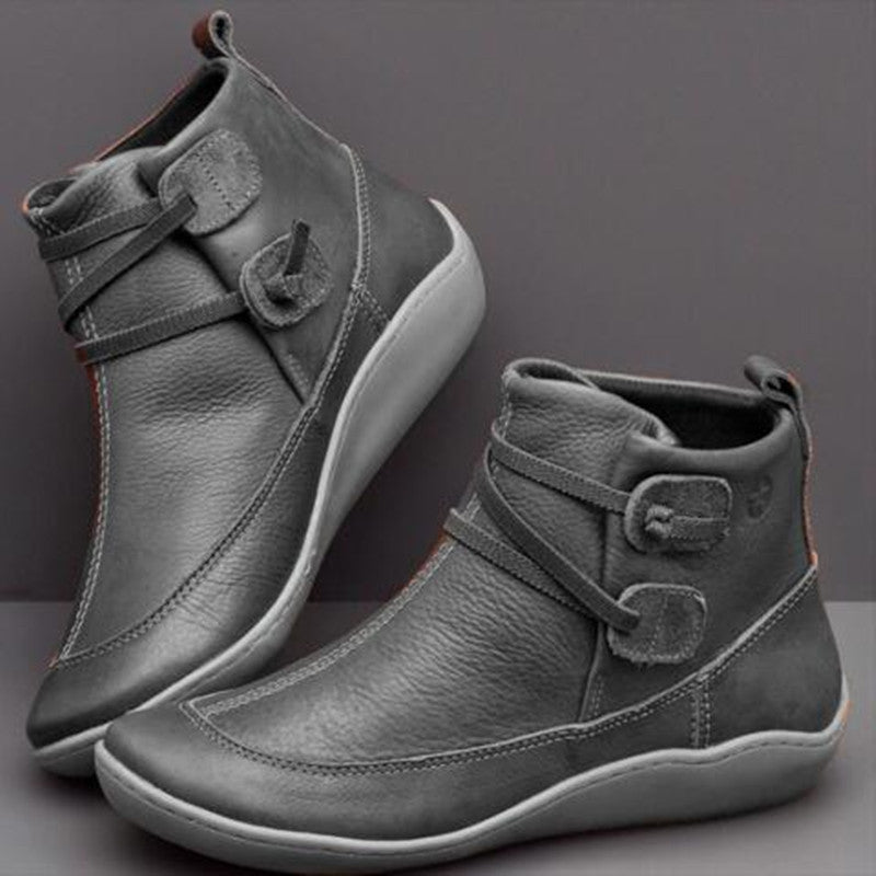 Comfortable orthopedic ankle boots for women, featuring button detail, arch support, and a wide toe box.
