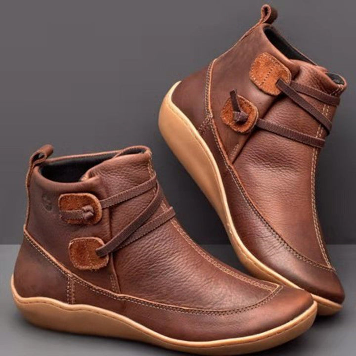 Stylish women's orthopedic ankle boots, comfortable footwear with arch support and distinctive button detail.