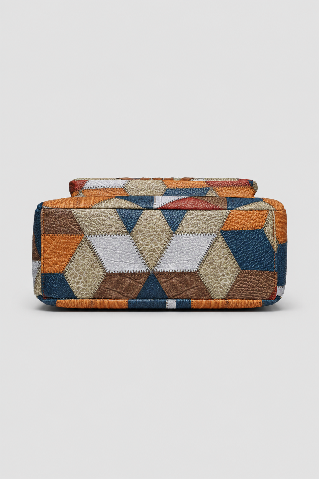 Stylish woman carrying a versatile patchwork shoulder bag, perfect fashion accessory for an elegant everyday look.