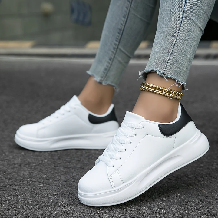 Chic women's platform sneakers featuring a stylish design and secure lace-up fit to elevate any casual outfit.
