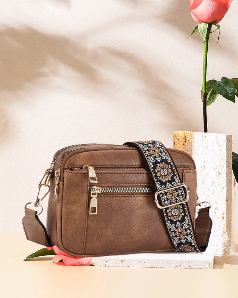 Fashion-forward women's black PU leather crossbody bag, highlighting its structured design