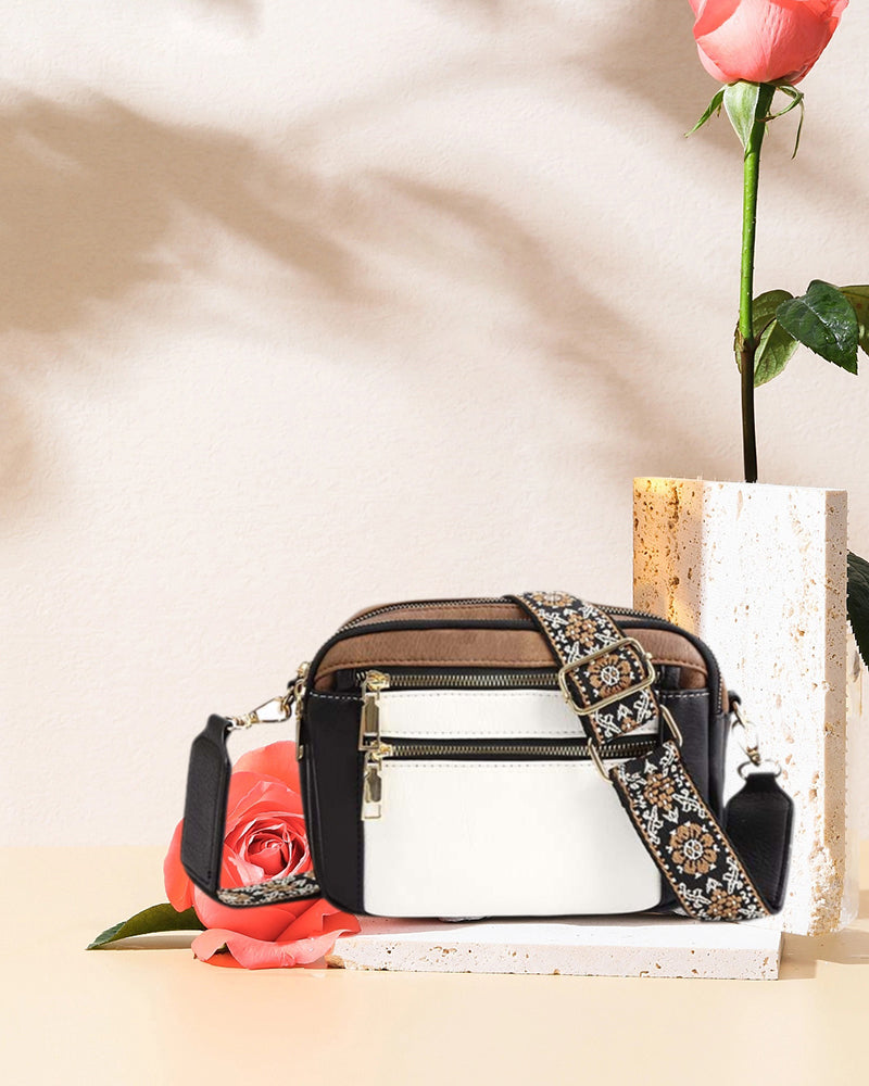 Adjustable strap detail on a women's black PU leather crossbody bag, showing hardware